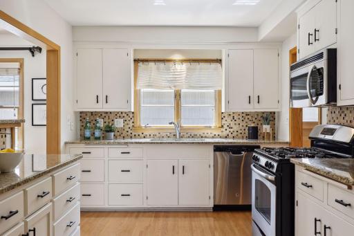 Spacious kitchen with tile backsplash.