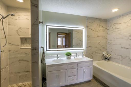 Nicely updated full bath w/ new led light vanity mirror, deep soaking tub & walk-in shower w/ tile surround & niche.