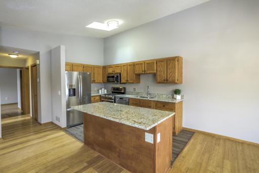 Nicely updated kitchen offers Stainless steel appliances, Granite countertops, Gas burning stove w/ double convection ovens, LVP flooring & Skylight.