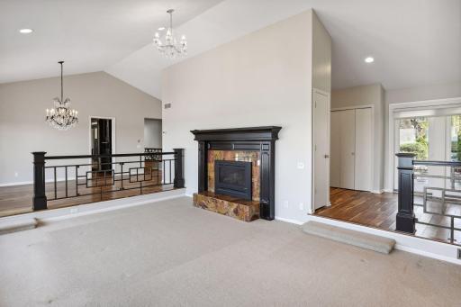 Living room with vaulted ceiling, an open airy feel and one of 3 cozy gas fireplaces