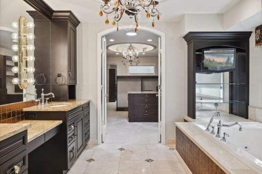 Primary bath flows into the stunning owner's closet