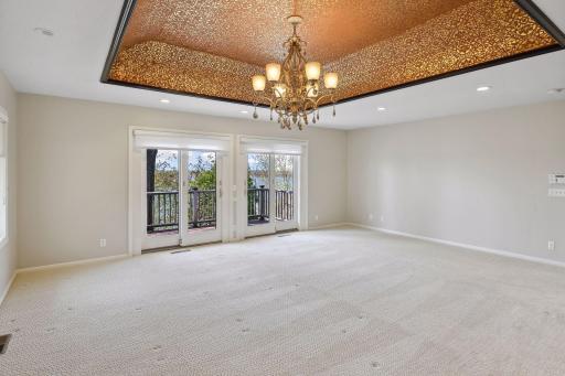 Spacious primary bedroom with private deck overlooking the lake