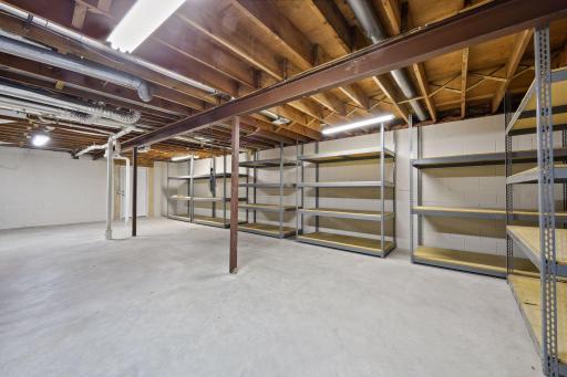 Huge unfinished space currently used for storage or bring your design ideas for added finished space. Door in the back corner leads to more storage space added along with the upstairs bath/closet addition