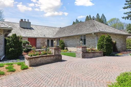 Beautiful paver driveway leads to the entry courtyard