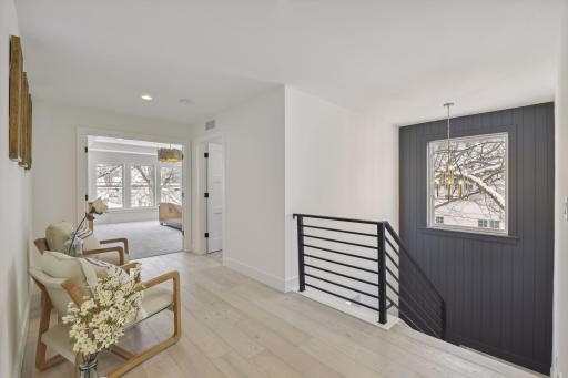 Wide upper level hollway leads to the Primary suite. Photos are from a previously built home.