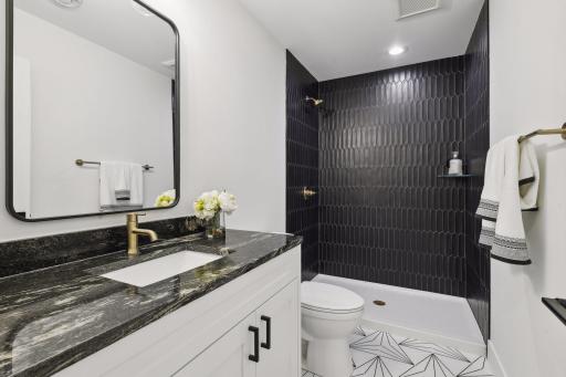 Lower level bathroom. Photos are from a previously built home.