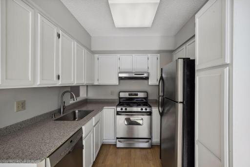 The kitchen boasts granite countertops, lovely cabinets and stainless steel appliances.