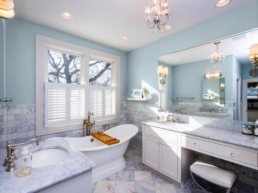 Primary bath with soaking tub and separate vanities.