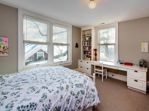 Bedroom 2 with custom cabinetry and desk.