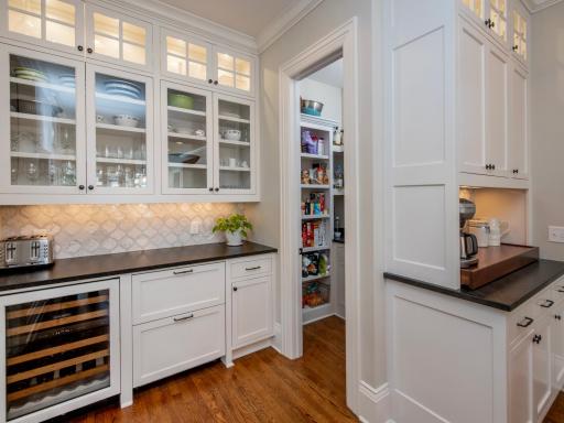 Pantry and beverage center with Sub Zero wine fridge and refrigerator drawers.