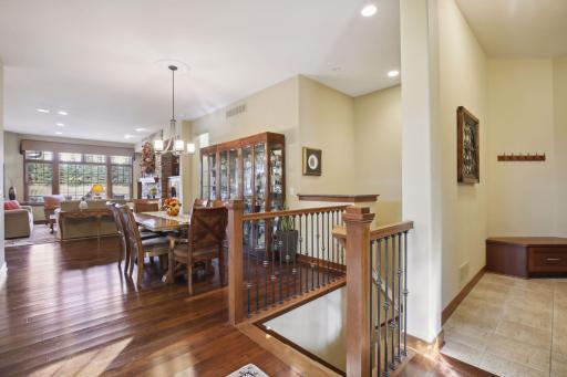 The 2 story open staircase boasts a custom wood and wrought iron railing.