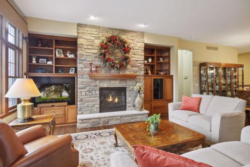 The stone fireplace and cherry built-ins are one of the many upgrades in this model home.