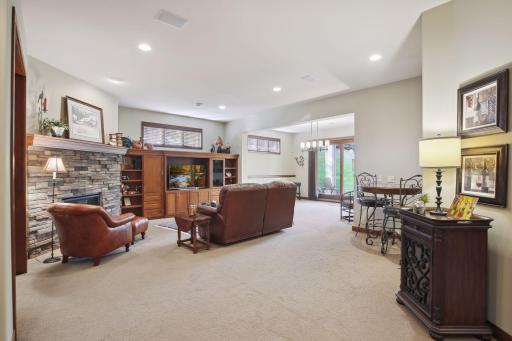 Bright lower level Family Room includes stone fireplace with cherry built-ins, a Game Area, custom cherry wet Bar Area, Billard Room, and a French door leading to a 14x11 paver Patio, a huge backyard, privacy and wooded views.