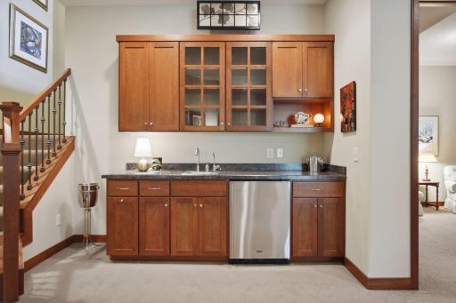 Upgraded wet Bar/Game Area with cherry cabinets, refrigerator and sink.
