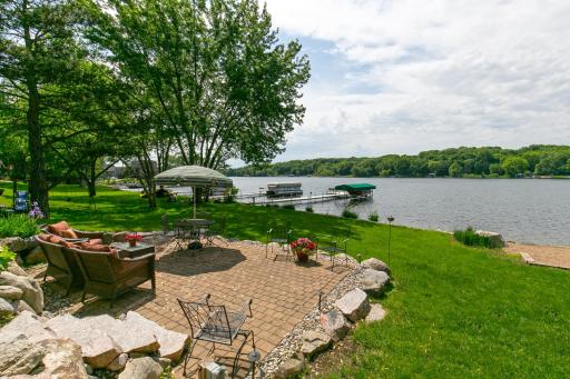 Enjoy 100-ft of PRIVATE lvl lakeshore, your own sandy beach, lakefront patio & maint-free dock