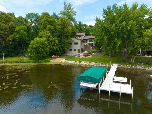 Enjoy 100-ft of PRIVATE lvl lakeshore, your own sandy beach, lakefront patio & maint-free dock
