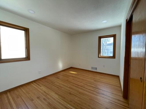 3rd main floor bedroom with LED lighting and beautifully refinished hardwood floors.