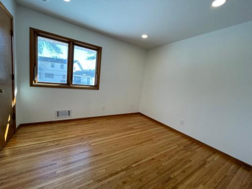2nd of 3 main floor berooms with updated LED lighting and beautifully refinished hardwood floors.