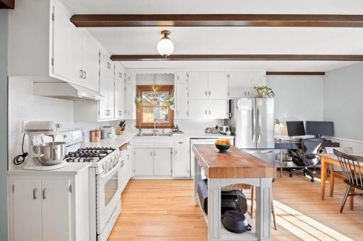 Beautifully renovated kitchen with painted cabinetry, quartz countertops, tile backsplash, and more!