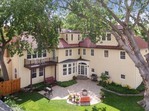 Northeast aerial view of rear yard, primary suite balcony, and rear patio.