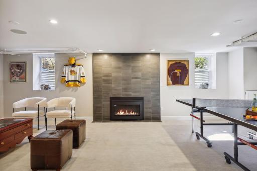 Basement entertainment room with natural gas fireplace insert