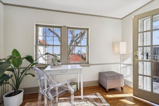 Primary bedroom sitting room with balcony access, Basilica and Minneapolis skyline views
