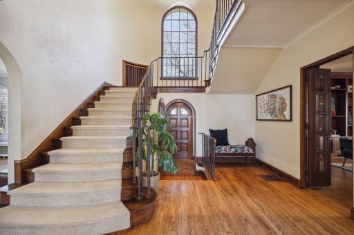 Main foyer and staircase with main entry and 1/2 bath