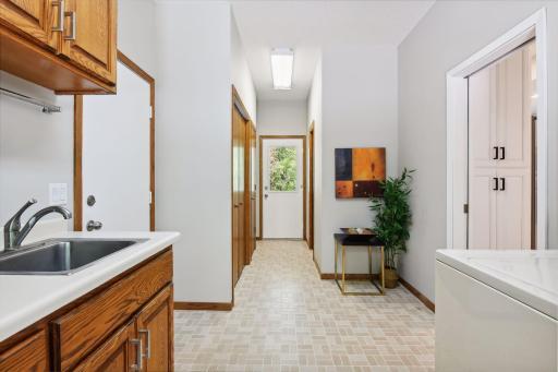 Mudroom area accesses oversized 3 car garage, has two storage closets and door access to deck