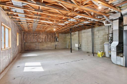 This space is directly under the upstairs bedrooms - so yes, you could fit three here or finish as you'd like. There is a door on the far left side to access backyard and rough in for bathroom on the right