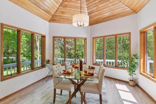 Sure to be a favorite room of yours - vaulted wood ceiling, new light fixture, surrounded by windows and wrap around deck