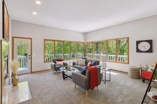 Sunken Living/Family Room with Wood-Burning Fireplace, Huge Windows overlooking Treed Yard and Access to Deck