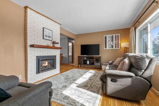Living room highlighted with brick gas fireplace