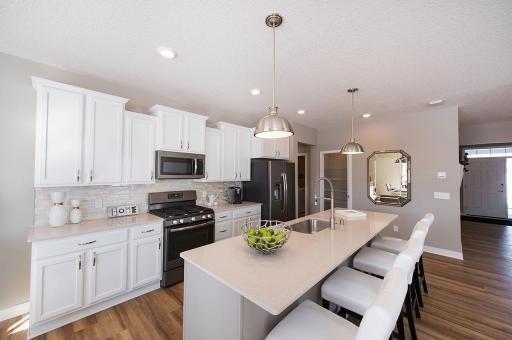 Photo for 3585 110th Lane NE, Blaine, MN 55449 - Listing #6344017 The kitchen is an entertainer's dream with the large island offering plenty of seating! *Note - photos are of a model, some features, options and colors will vary.