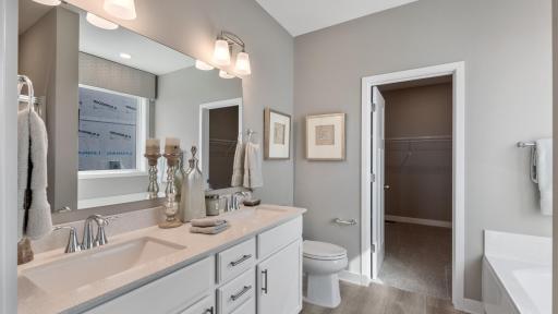 Photo for 3585 110th Lane NE, Blaine, MN 55449 - Listing #6344017 Owner's bathroom features a double vanity with a separate tub and shower. *Note - photos are of a model, some features, options and colors will vary.