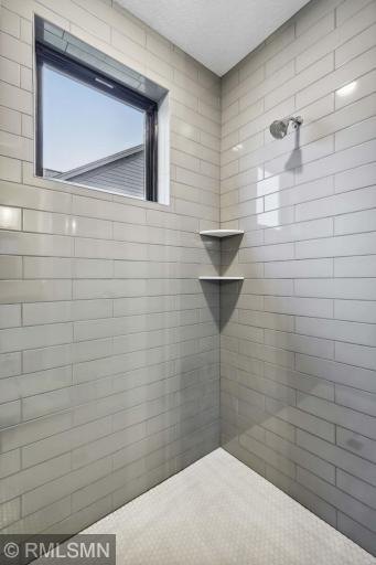 Custom tiled shower w frameless glass door