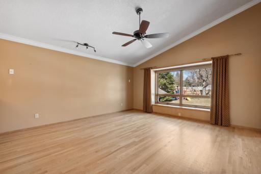 Great Room with beautiful hardwood flooring, vaulted ceiling, crown moulding, and updated windows throught the home.