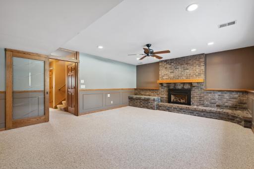 Cozy gas fireplace, custom seating area, and beautiful sliding glass door with transom window!