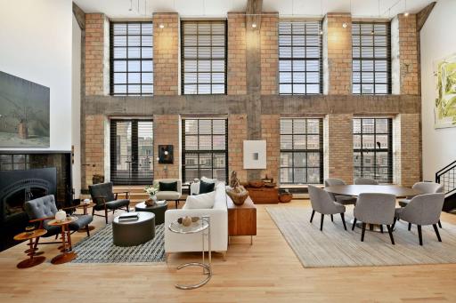 Extraordinary 7th floor penthouse loft with soaring 20' ceilings and a wall of windows providing a voluminous space with abundant natural light and city skyline views.