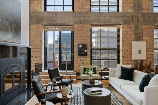 Two outdoor spaces included: a main level balcony directly accessible from the living room and a private rooftop cabana directly accessible from the upper mezzanine level.