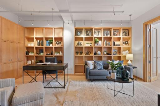 The main level den includes built-in library shelving and home office cabinetry.