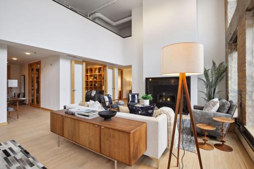 The main level den features two sets of glass-paned french doors; one that opens to the living area and another that opens to the entry hall.