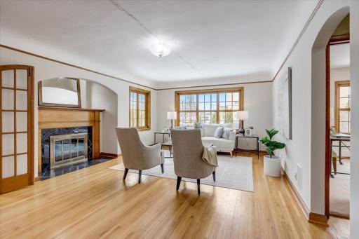 Cozy up next to the wood-burning fireplace in the spacious living room upon entry, which showcases the gorgeous hardwood floors that extend throughout much of the home.