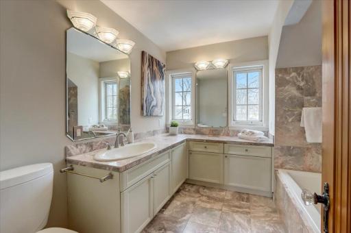 Shared three-quarter bathroom completes the upper level with tile surround, and large vanity providing tons of storage.