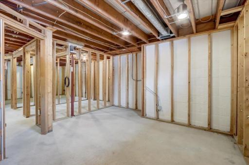 Large unfinished framed lower level provides the opportunity to make it your own, utility room which doubles as the laundry room + ¼ bathroom, all roughed-in and ready to be completed as a full bathroom with a large corner tub!