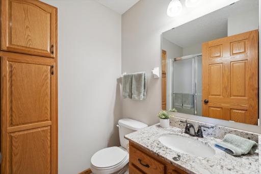 Another three-quarter bath is conveniently located to serve the main living areas and the second bedroom.