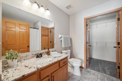 This private full bath and walk-in closet are part of the primary bedroom suite.