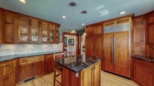 Simply Breathtaking Gourmet Kitchen with Custom Cherry Cabinetry, Bay Window, Granite Countertops, Birch Flooring, Commercial Grade Appliances, Tumbled Marble Backsplash, Undercabinet Lighting (finished underneath)