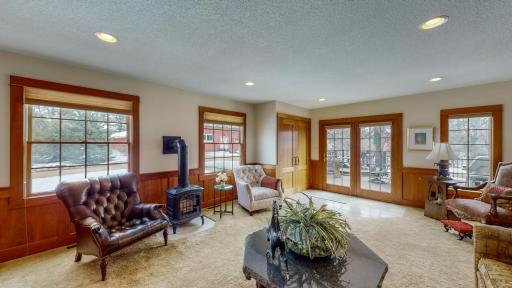 Family Room with Coat Closet, Large Windows allowing Natural Lighting and Free Standing Fireplace.