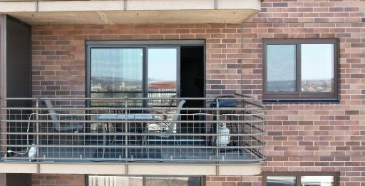 Oversized sliding glass door and balcony.