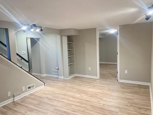 Lower level family room with a built in shelf.